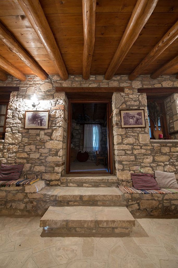 Vakakis Winery stone entrence with two photos in a frames on the both sides